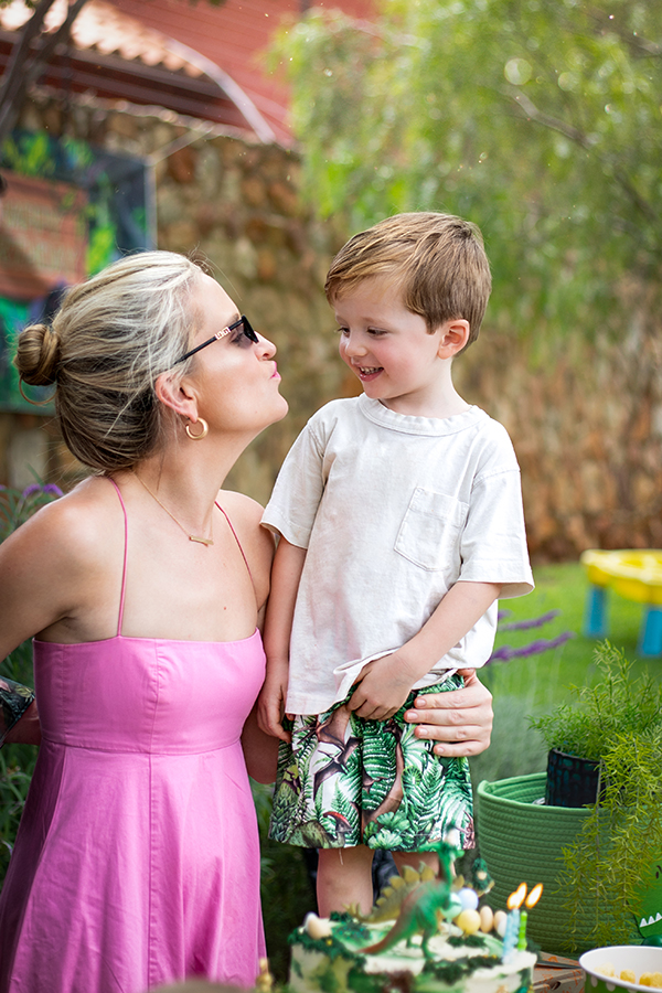 mom and son by birthday cake